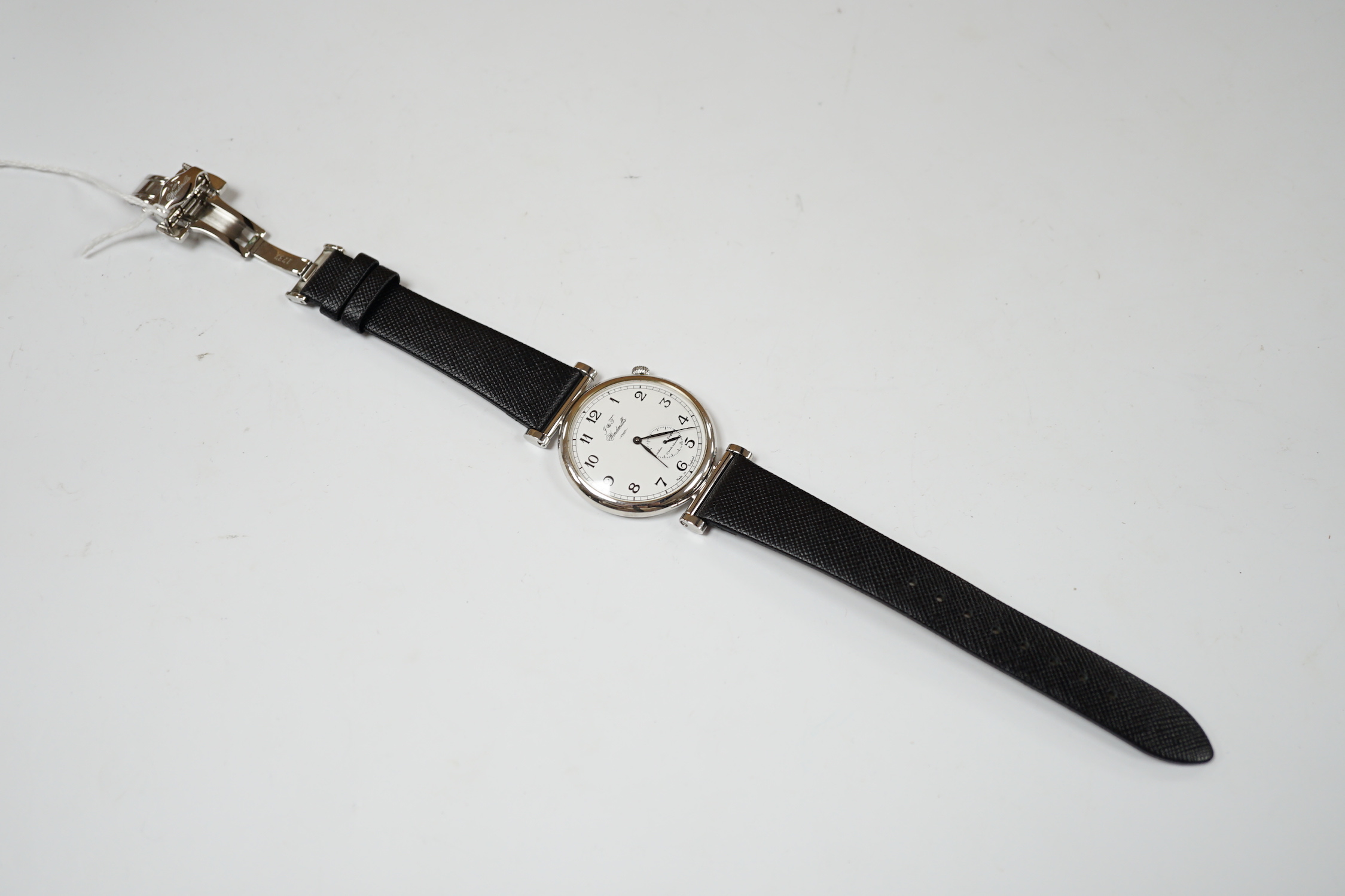 A gentleman's 2006 Joseph & Thomas Windmills Bartholomew First Edition white metal (stamped 950 for platinum) manual wind wrist watch, numbered 00144/00150, on leather strap with stainless steel deployment clasp, with or